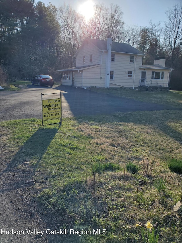 exterior space with driveway and a front yard