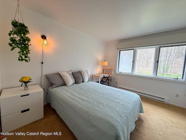 bedroom with baseboard heating and dark colored carpet
