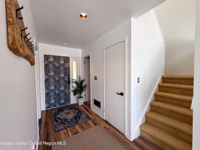 entryway with recessed lighting, baseboards, stairs, and wood finished floors