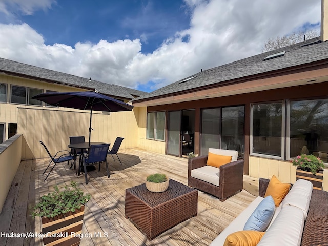 view of patio / terrace featuring outdoor lounge area, a wooden deck, and outdoor dining space