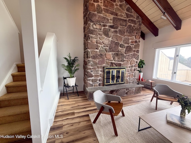living room with wood ceiling, beam ceiling, stairs, and wood finished floors