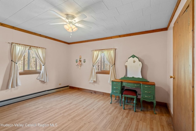 office with baseboard heating, wood finished floors, and a healthy amount of sunlight