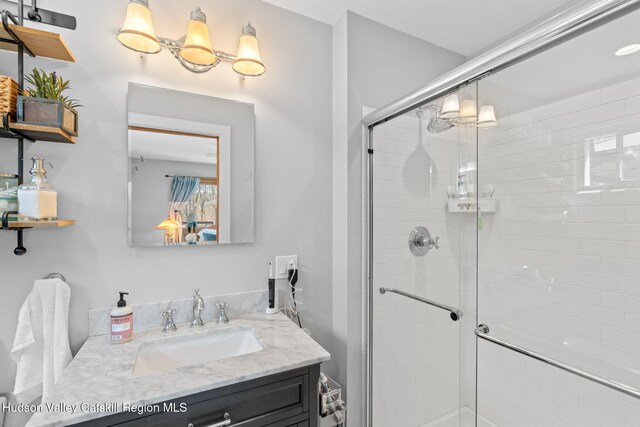 bathroom featuring vanity and a stall shower