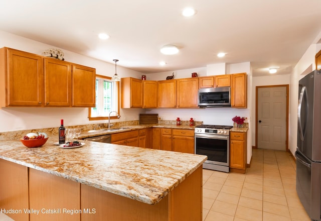 33 Camelot Ct, Saugerties, NY 12477 - kitchen featuring stainless steel appliances, a sink, a peninsula, light stone counters, and light tile patterned floors