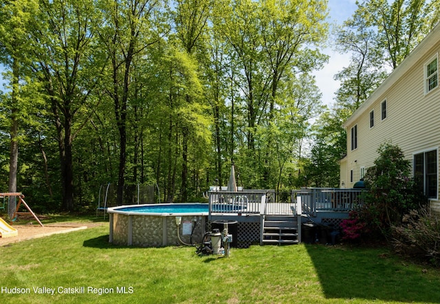 33 Camelot Ct, Saugerties, NY 12477 - view of grassy yard featuring an outdoor pool, a deck, and a playground