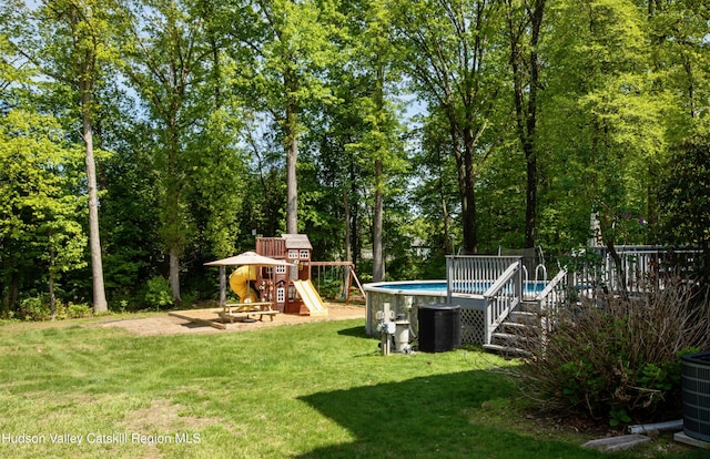 33 Camelot Ct, Saugerties, NY 12477 - view of grassy yard featuring a playground and an outdoor pool