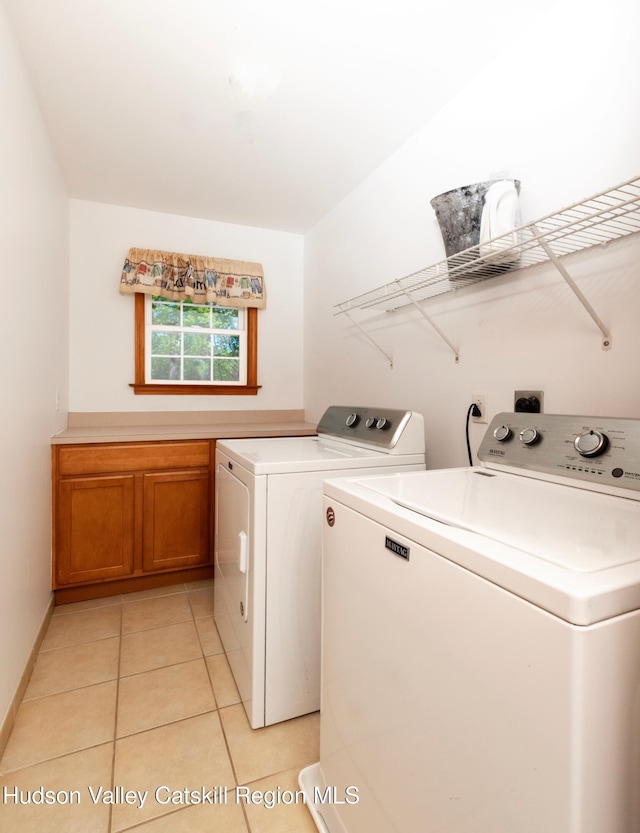 33 Camelot Ct, Saugerties, NY 12477 - washroom featuring separate washer and dryer, cabinet space, and light tile patterned floors