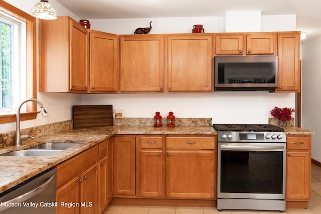33 Camelot Ct, Saugerties, NY 12477 - kitchen with appliances with stainless steel finishes, a sink, light tile patterned floors, and light stone countertops