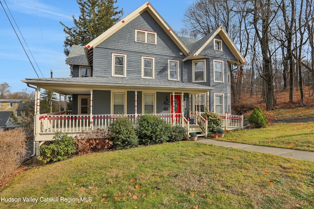 view of front facade with covered porch and a front lawn