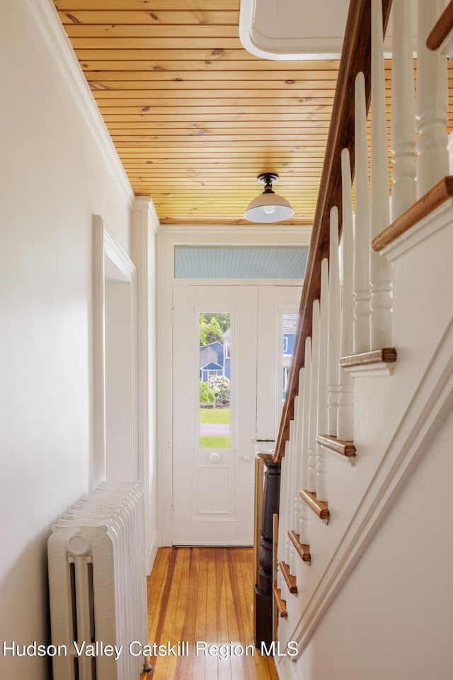 14 Bushnell Ave, Chatham, NY 12037 - foyer entrance featuring wooden ceiling, radiator, stairway, light wood-style flooring, and ornamental molding