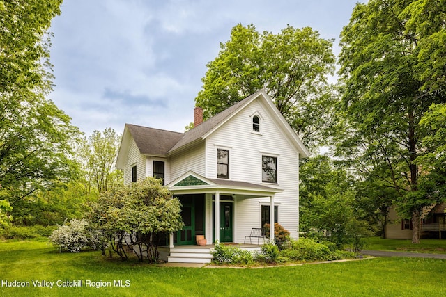 14 Bushnell Ave, Chatham, NY 12037 - view of front facade featuring a porch, a chimney, a front lawn, and a shingled roof