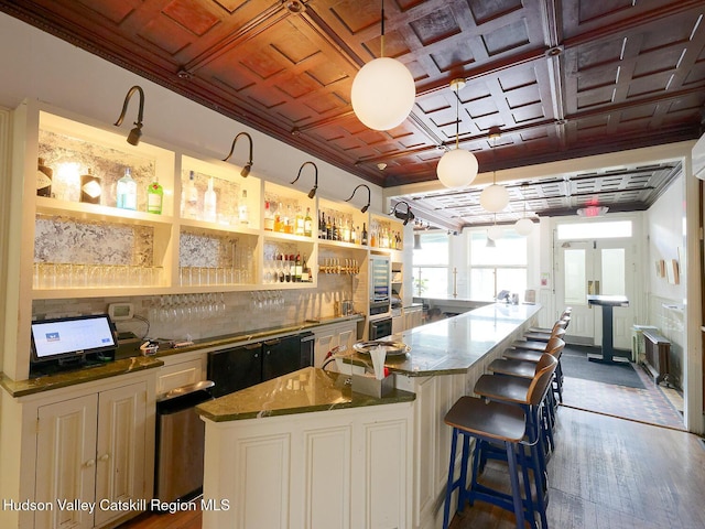 230 Warren St, Hudson, NY 12534 - kitchen featuring an ornate ceiling, oven, dark wood-style flooring, a breakfast bar area, and a spacious island