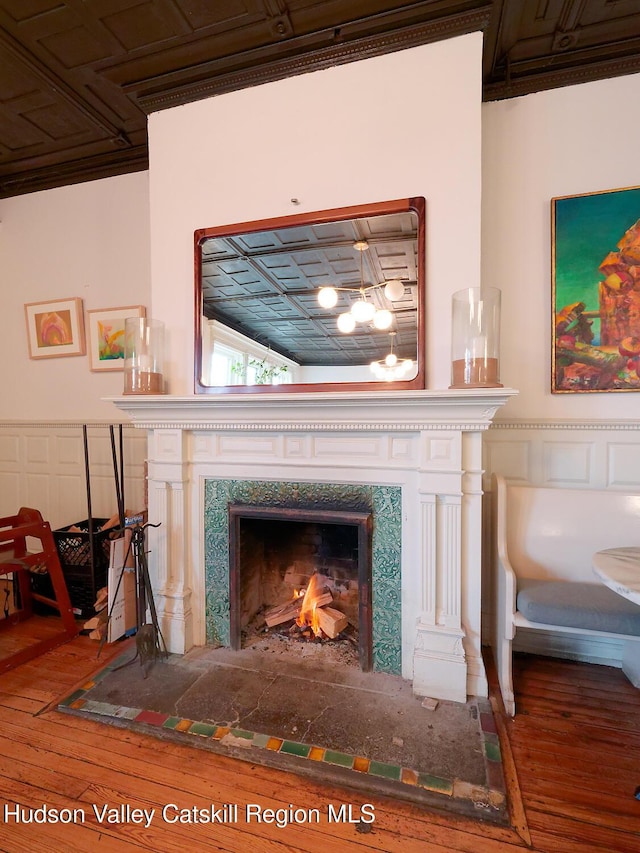 230 Warren St, Hudson, NY 12534 - detailed view of wood finished floors, a high end fireplace, and a chandelier
