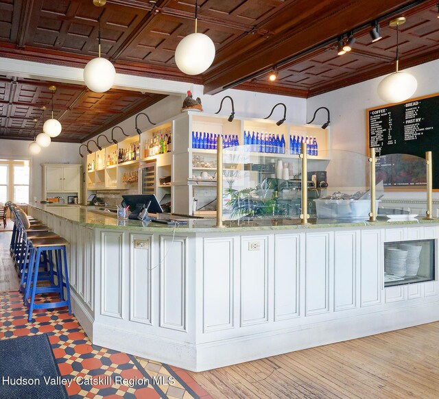 230 Warren St, Hudson, NY 12534 - kitchen with rail lighting, ornamental molding, and decorative light fixtures