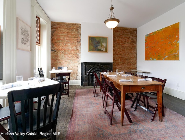230 Warren St, Hudson, NY 12534 - dining area featuring wood finished floors, a multi sided fireplace, and baseboards