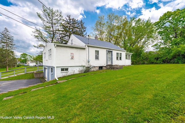 334 Joslen Blvd, Hudson, NY 12534 - back of property featuring asphalt driveway, a garage, and a chimney