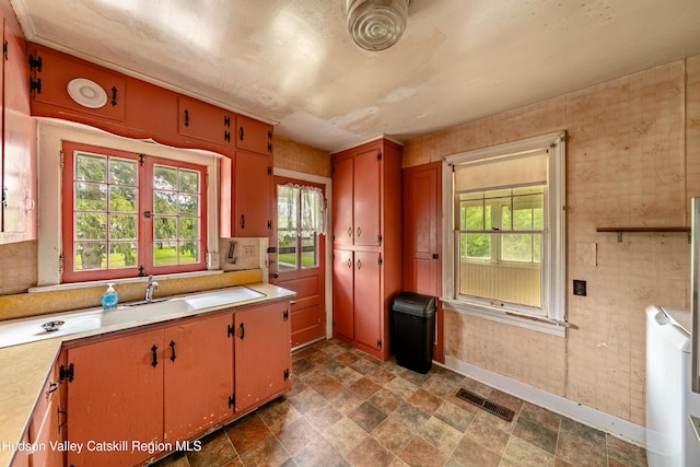 334 Joslen Blvd, Hudson, NY 12534 - kitchen with light countertops, stone finish flooring, baseboards, and a sink