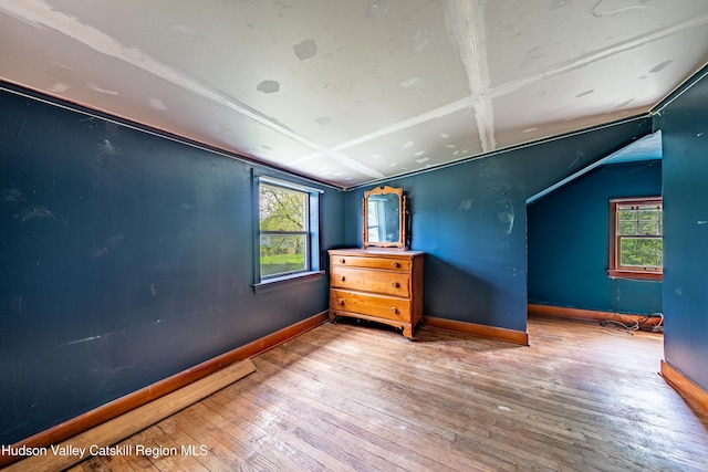 334 Joslen Blvd, Hudson, NY 12534 - unfurnished bedroom featuring hardwood / wood-style flooring, baseboards, and lofted ceiling