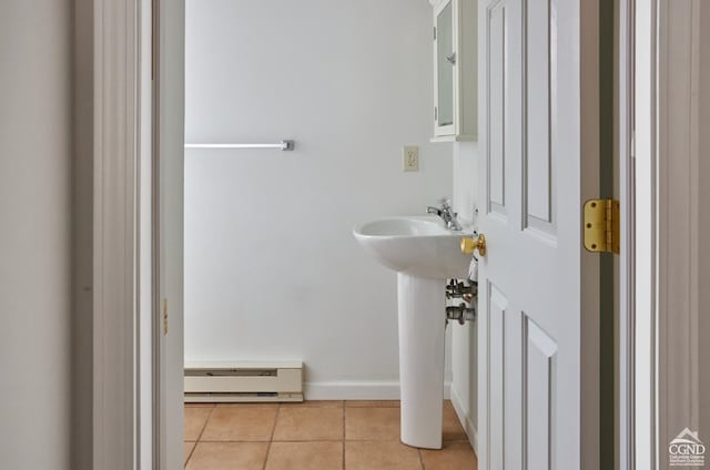 bathroom with a baseboard heating unit and tile patterned floors