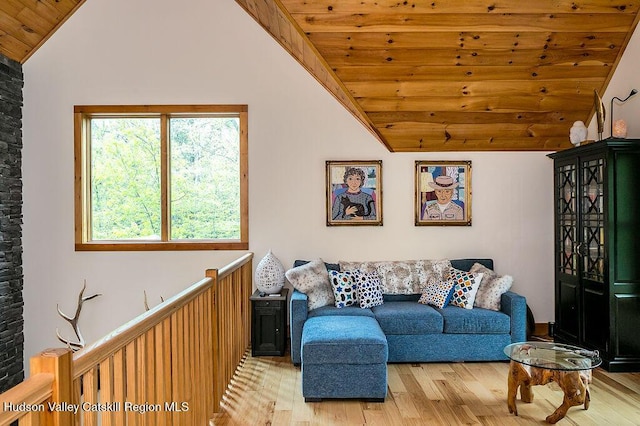 sitting room featuring vaulted ceiling, light wood-style floors, and wooden ceiling