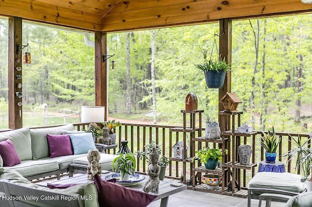 sunroom with a wooded view