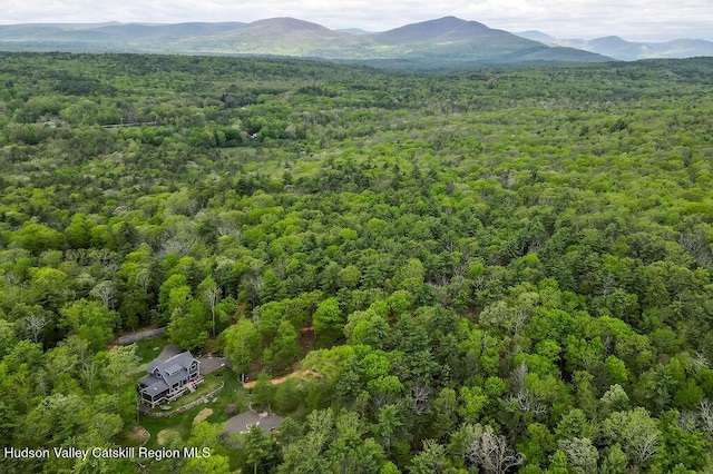 aerial view of a heavily wooded area and mountains