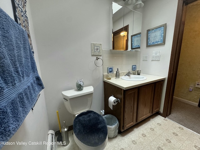 bathroom with vanity, backsplash, and toilet