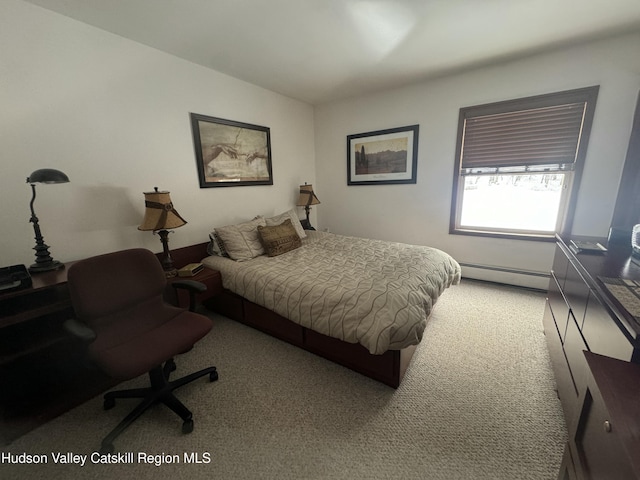 carpeted bedroom featuring a baseboard heating unit