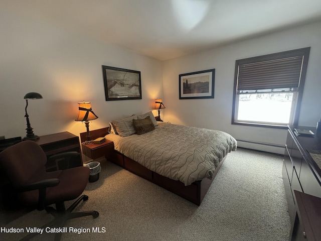 bedroom featuring a baseboard heating unit and carpet flooring