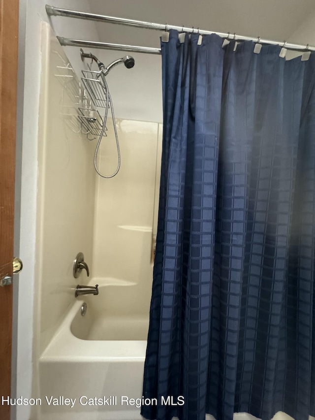 bathroom with shower / bath combination with curtain