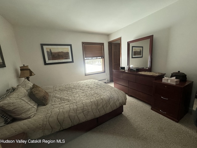 bedroom featuring light carpet and a baseboard radiator