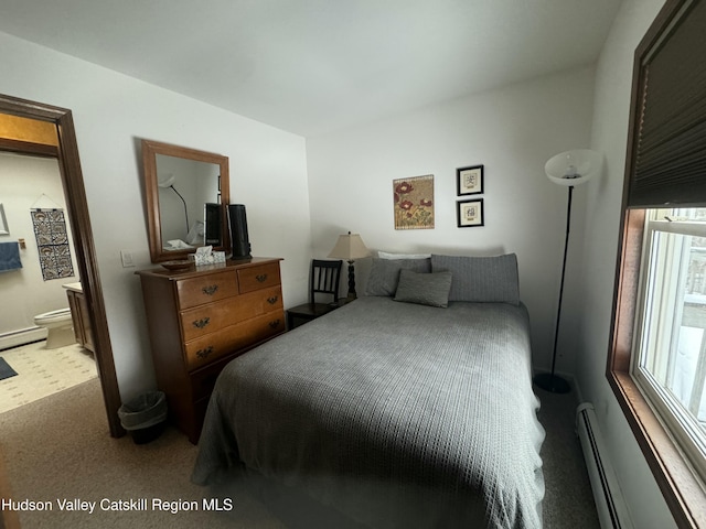 bedroom featuring a baseboard radiator, ensuite bathroom, and light carpet