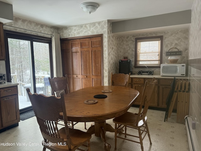 dining space with a baseboard radiator