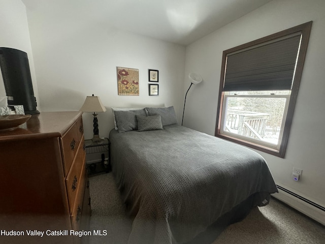 carpeted bedroom featuring baseboard heating