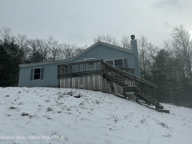 snow covered property featuring a wooden deck