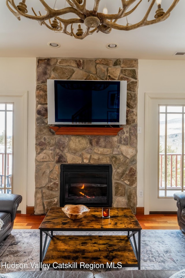 living room with hardwood / wood-style floors and a fireplace