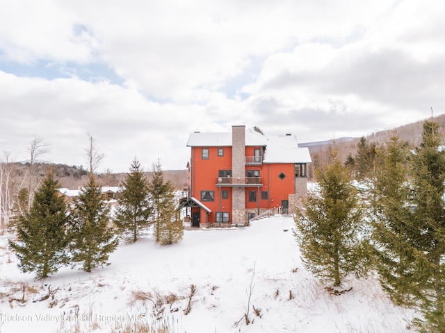 view of snow covered rear of property