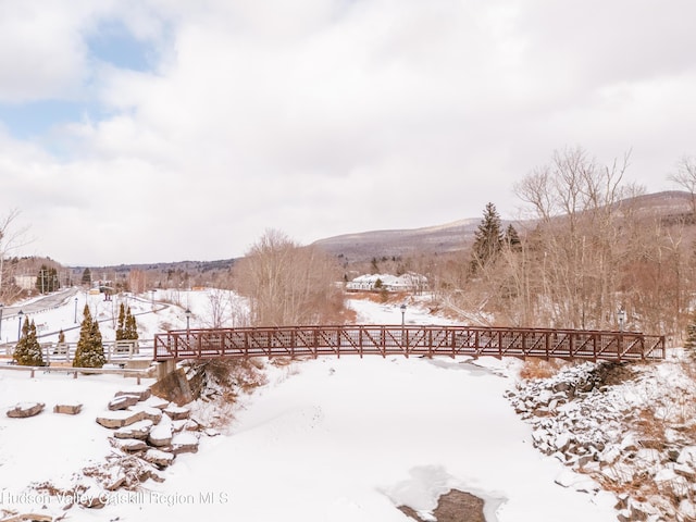 snowy yard with a mountain view