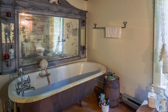 full bathroom featuring a soaking tub and baseboard heating