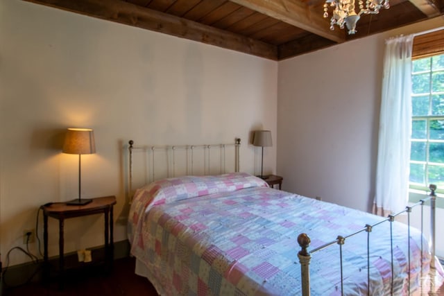 bedroom featuring wood ceiling, beamed ceiling, and a chandelier