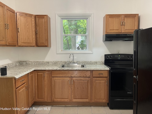 6 Church St, Ellenville, NY 12428 - kitchen with under cabinet range hood, black appliances, and brown cabinets