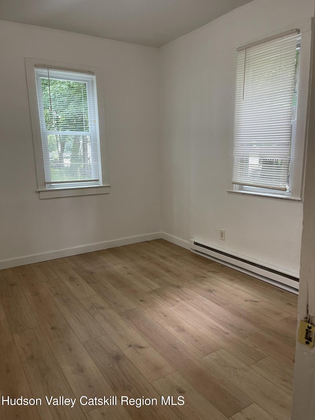 6 Church St, Ellenville, NY 12428 - unfurnished room featuring a baseboard radiator and light wood-type flooring