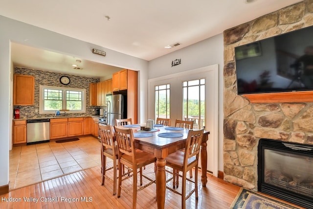 6 Trailside Dr Unit A8, Hunter, NY 12442 - dining area featuring a fireplace and light wood-style floors