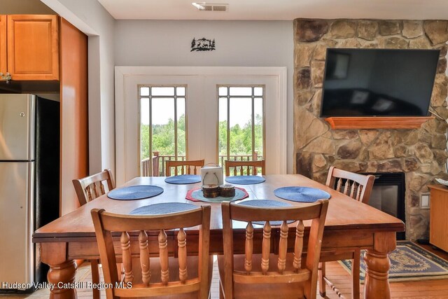 6 Trailside Dr Unit A8, Hunter, NY 12442 - dining space featuring a stone fireplace and wood finished floors