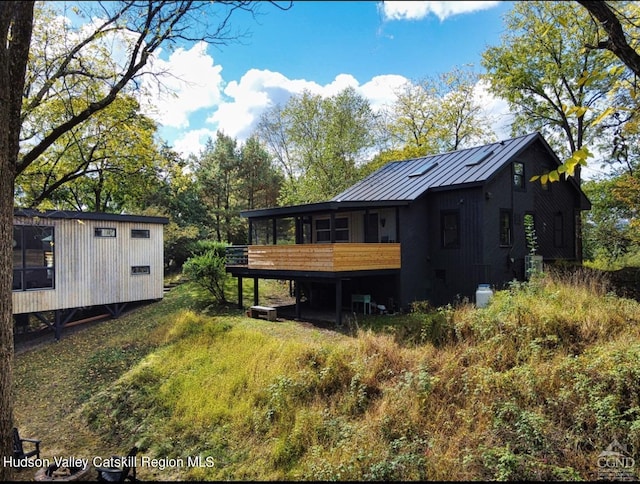 back of property with a wooden deck