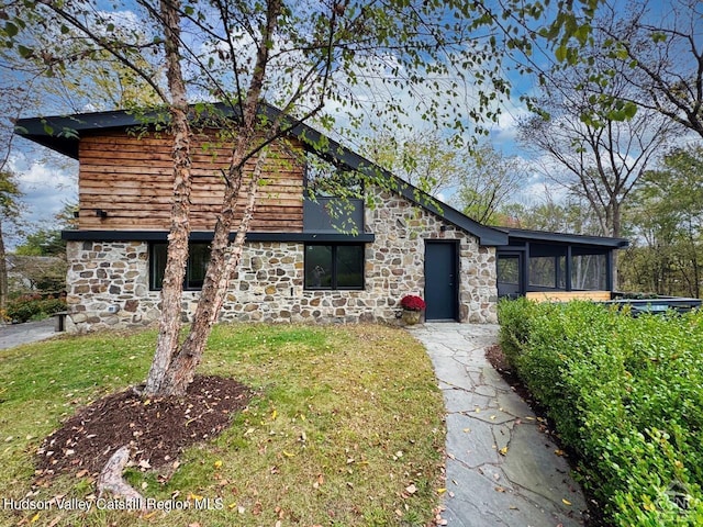 view of front of house featuring a front yard and a sunroom