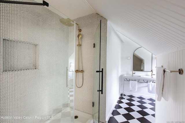 bathroom featuring a shower with shower door and vaulted ceiling