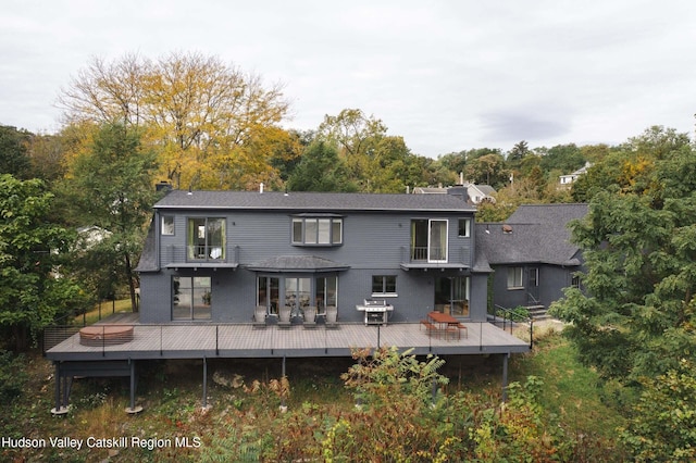 back of house with a wooden deck