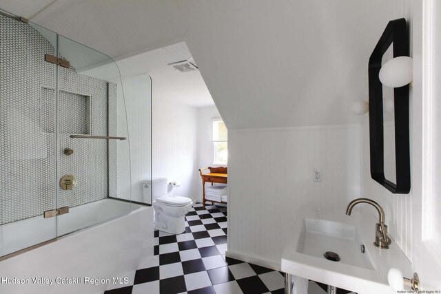 full bathroom with sink, combined bath / shower with glass door, and toilet