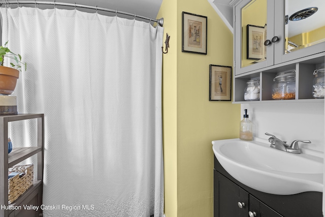 bathroom featuring vanity and curtained shower